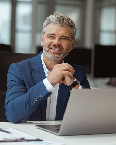Image of man in office with a laptop